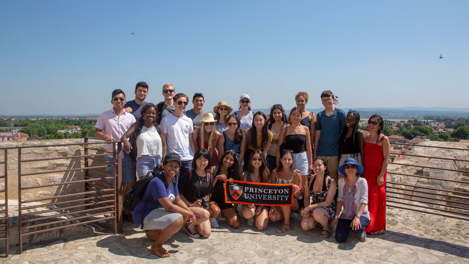 Students and faculty pose with Princeton University banner in France
