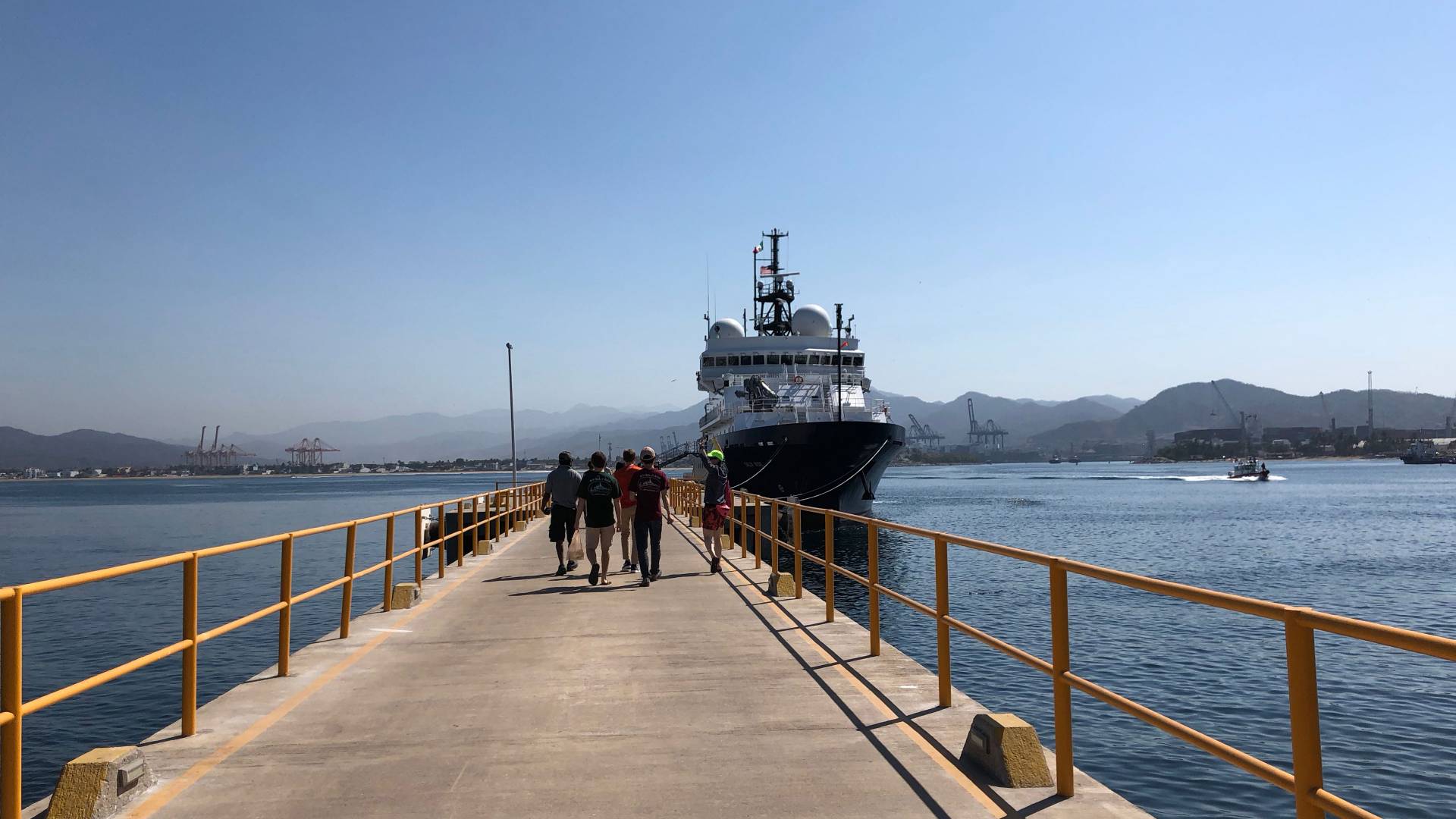 Scientists walking back to the research vessel Sally Ride at the dock in Manzanillo, Mexico