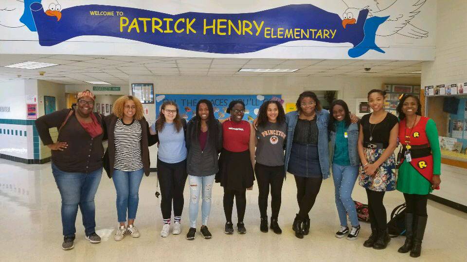 Students standing under banner for Patrick Henry Elementary School