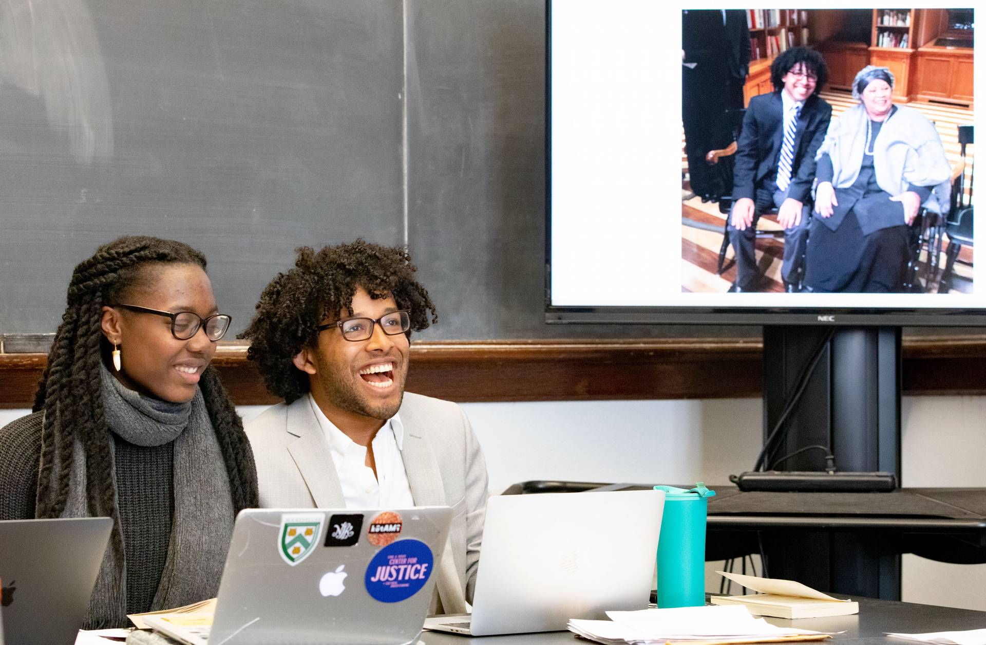 Two students present a slide showing one of the students meeting Toni Morrison herself