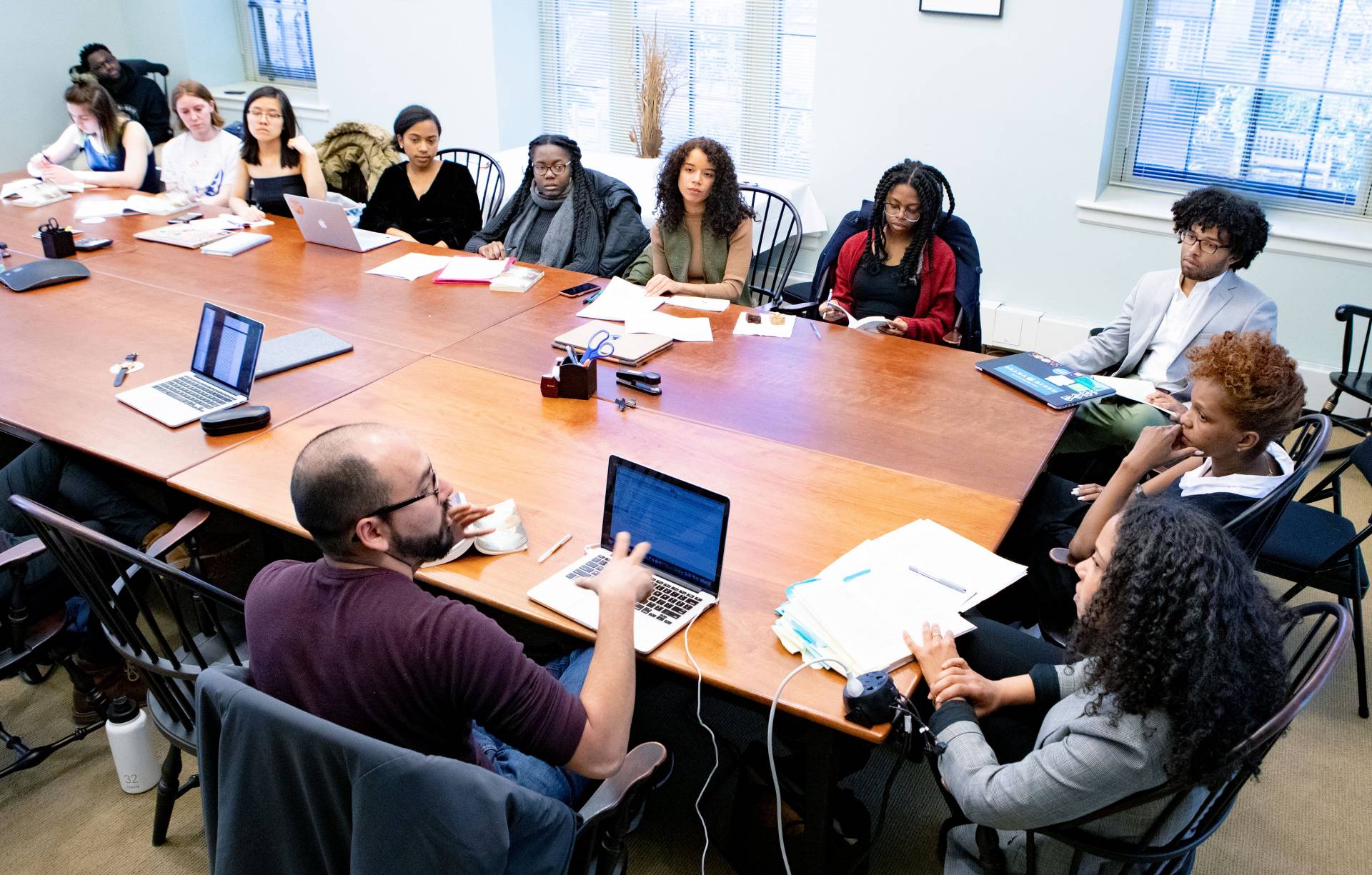 Students sit at a table discussing the works of Toni Morrison