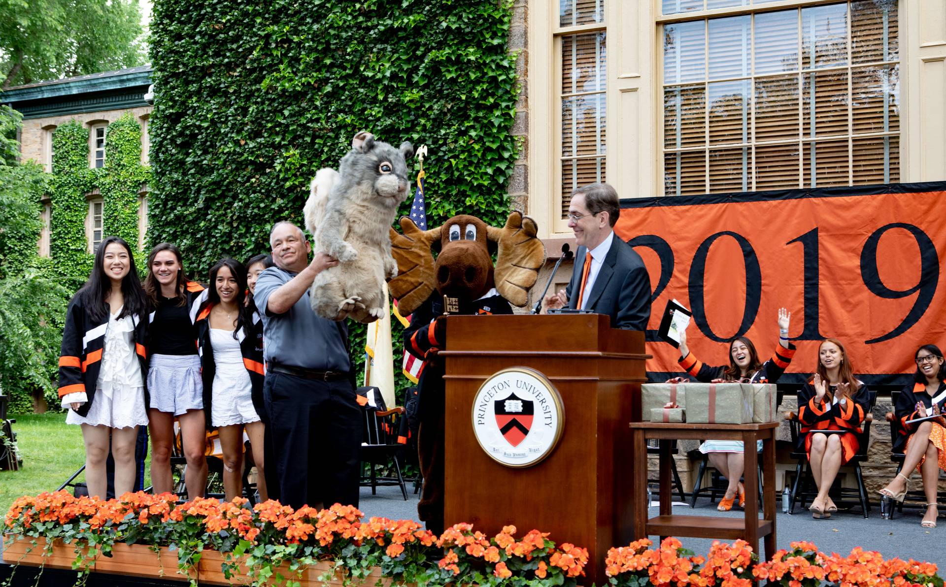 President Christopher L. Eisgruber presents a stuffed squirrel to the class