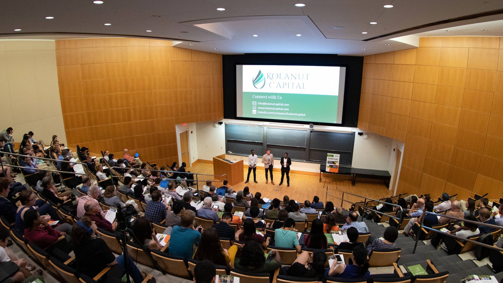 Teams presenting in an auditorium