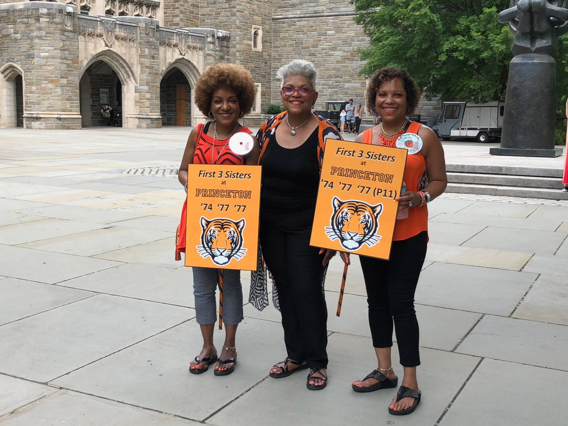 Daphne, Evora, and Ivy at Reunions 2018, holding signs that read: " First 3 sisters at Princeton '74, '77, '77