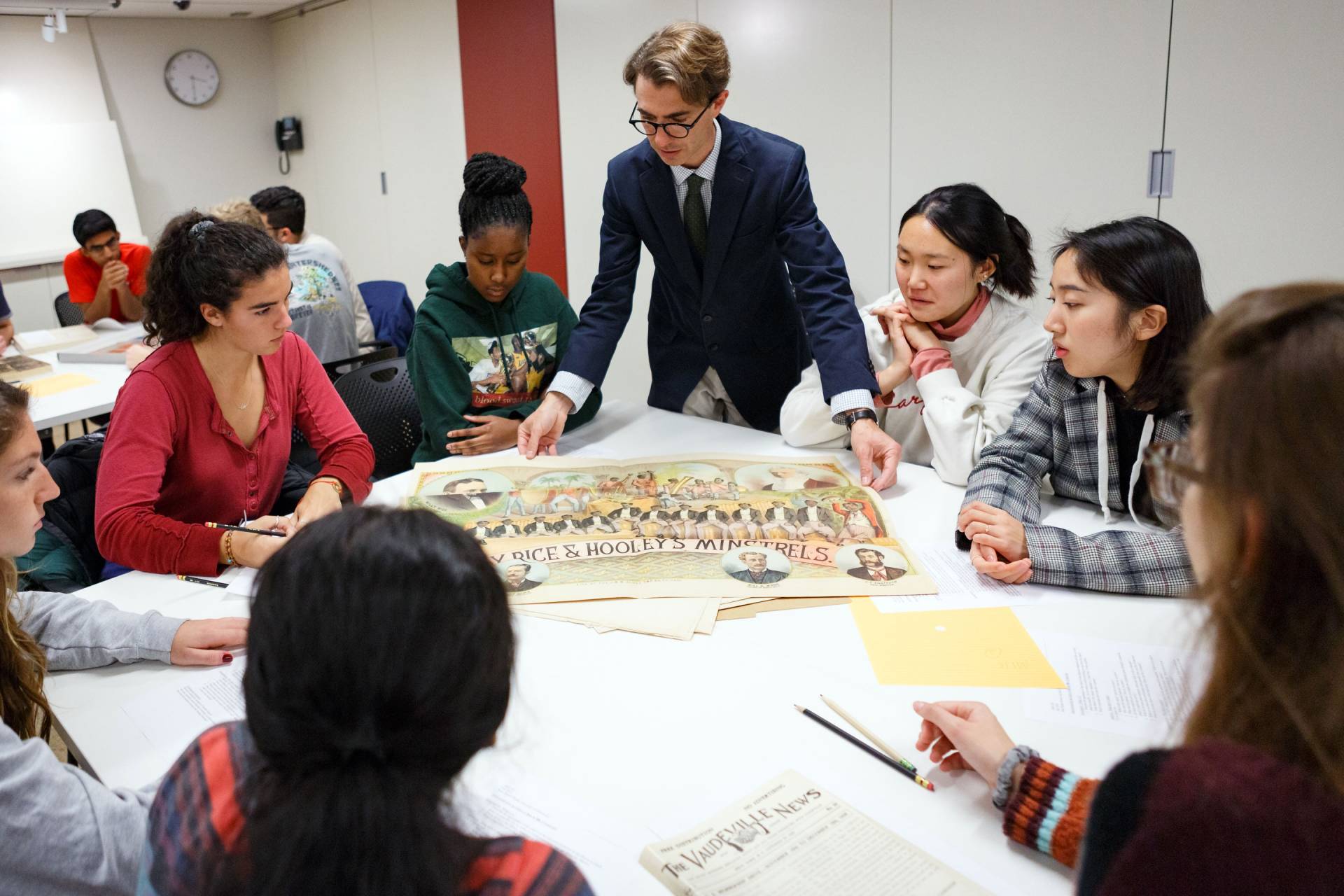 Professor and students look at materials from special collections