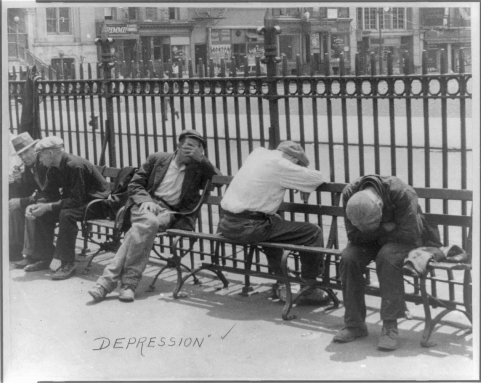 Men slumped over while seated on a bench
