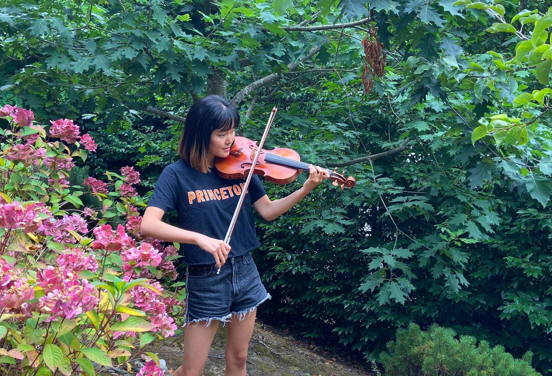 Cammie Lee practicing violin her yard in Portland, Oregon