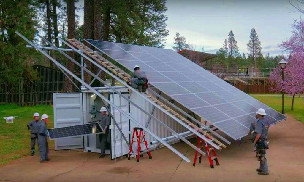 Workers set up a microgrid, complete with solar panels