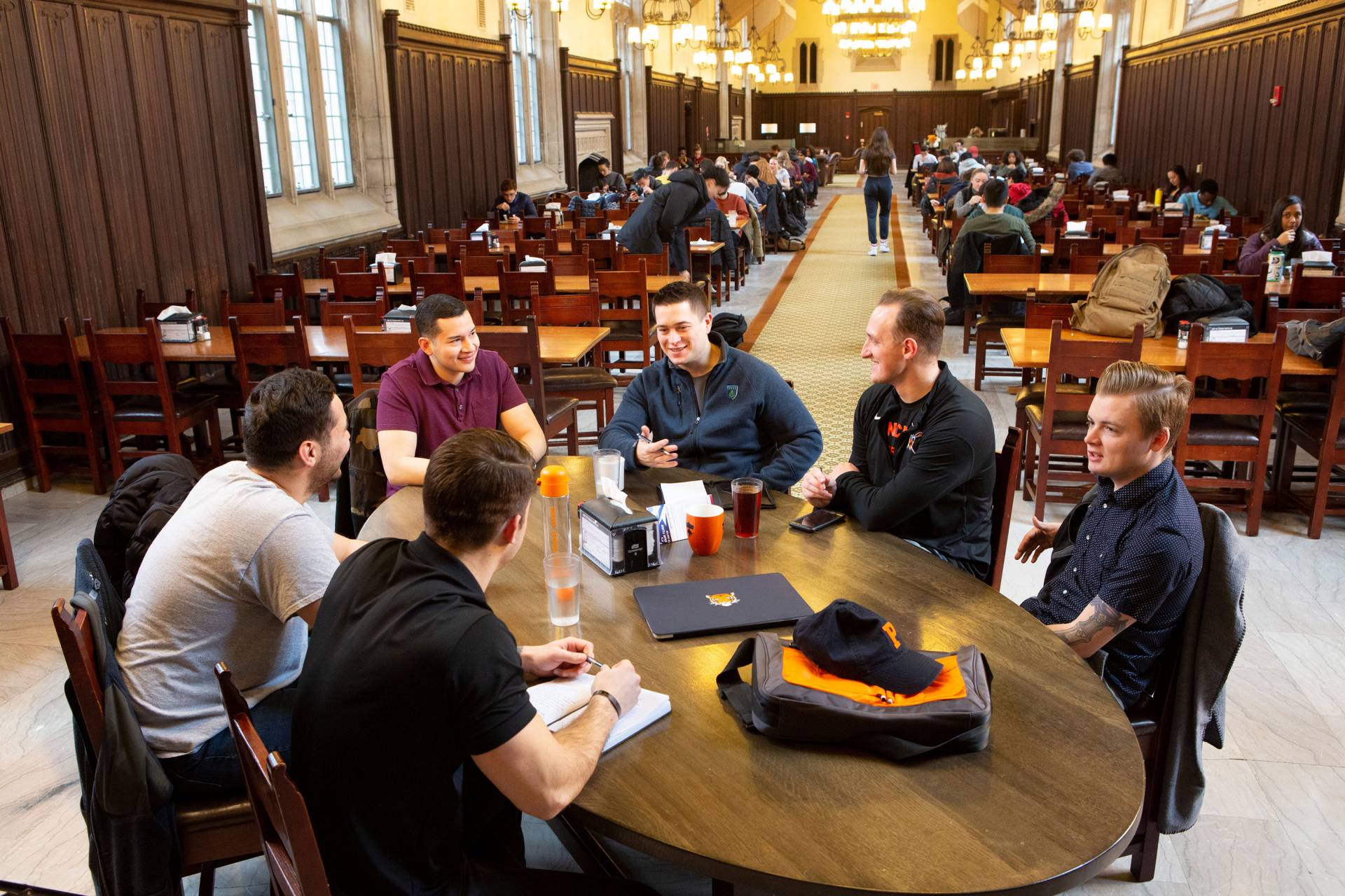 Students share a table in a dining hall