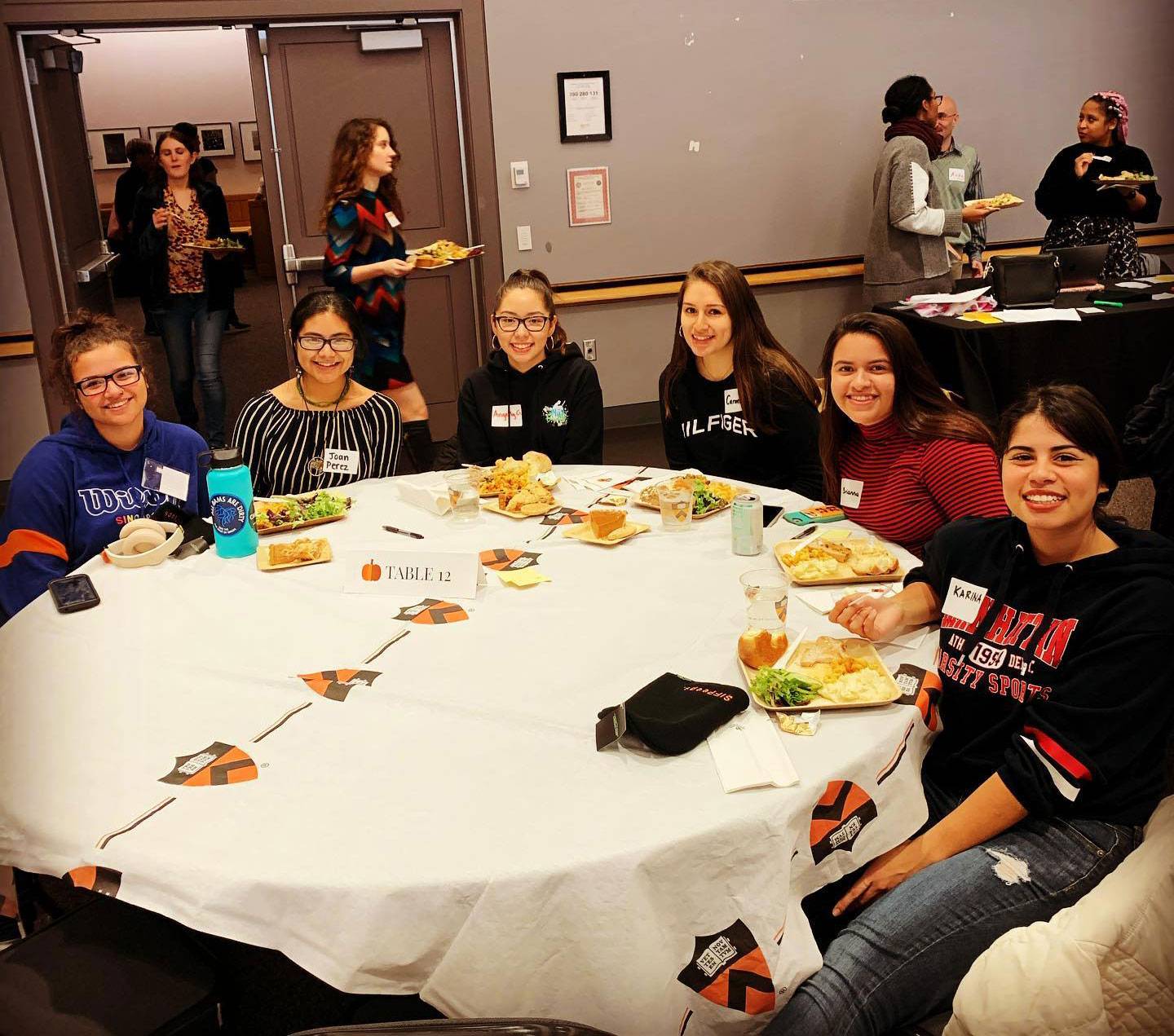 Students share a meal together at a table