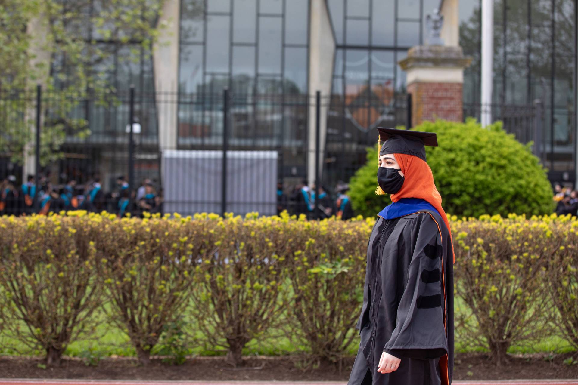 A graduate student walks to the stadium