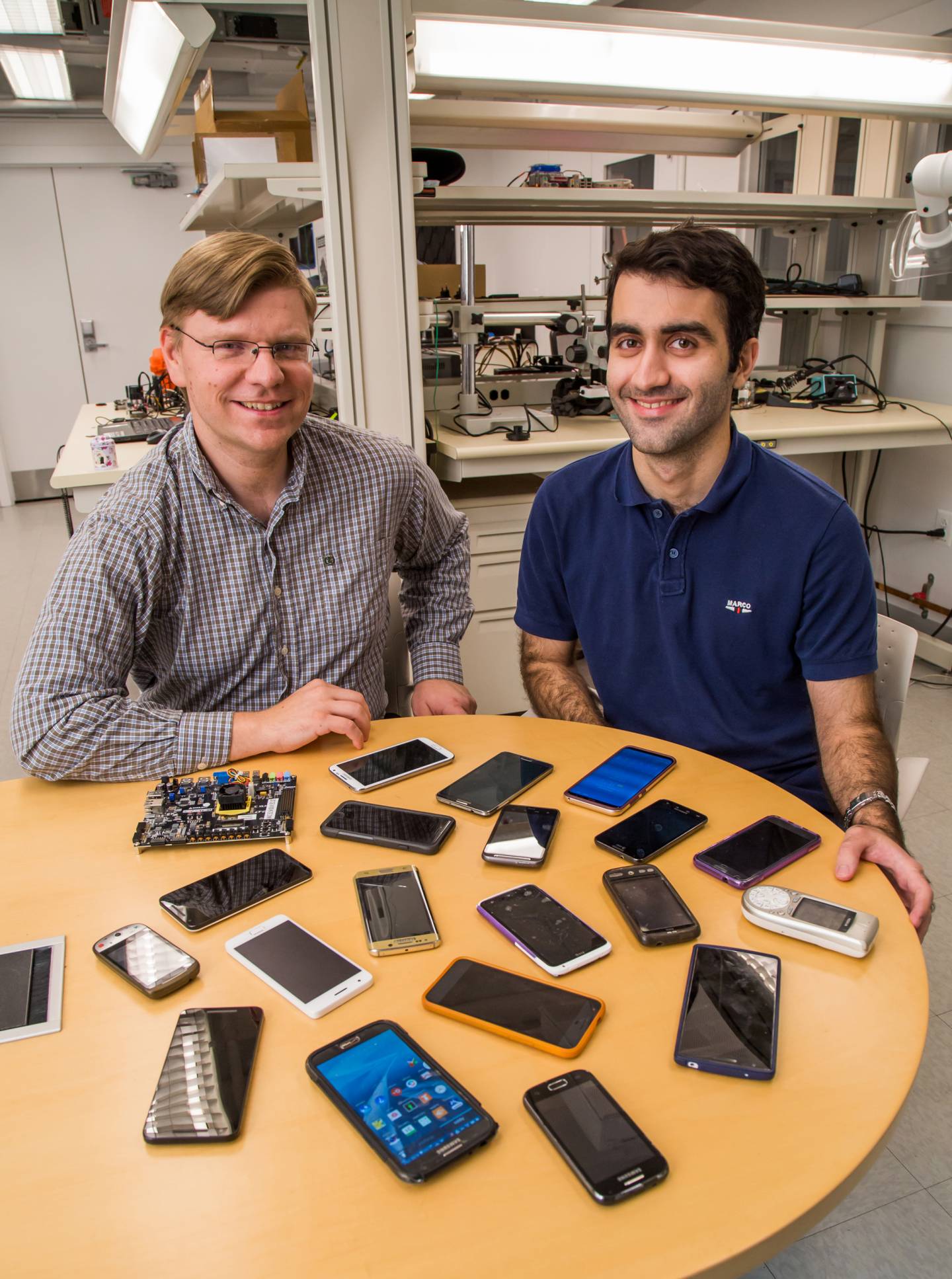 David Wentzlaff and Mohammad Shahrad sit with smart phones on a table