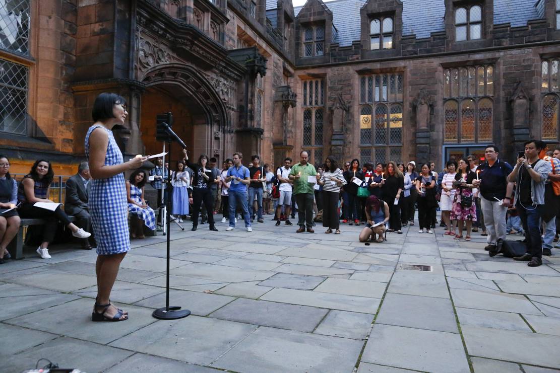 Hua Qu speaks at vigil on campus for her husband, Xiyue Wang.