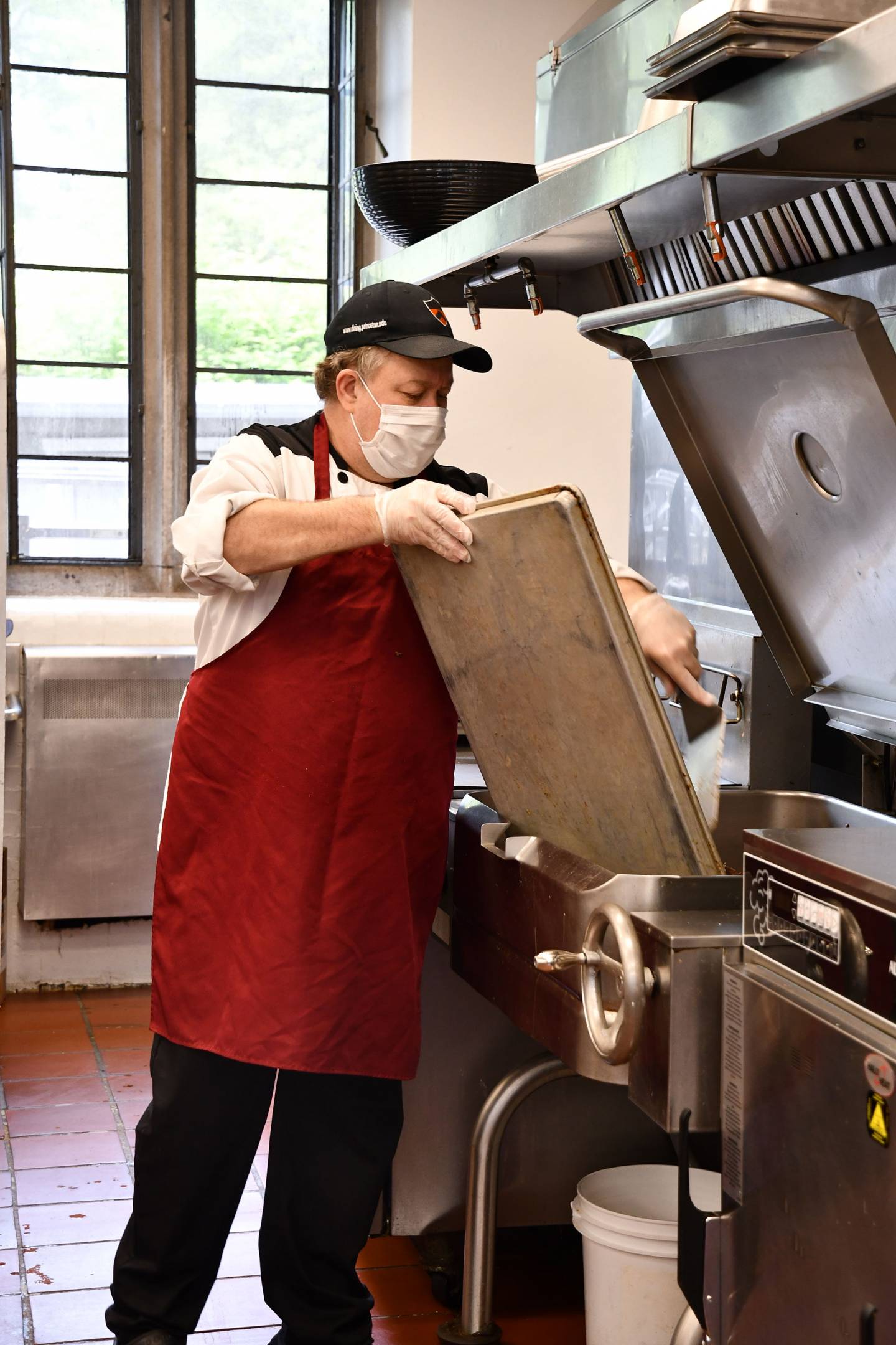 A campus Dining employee handles a sheet pan