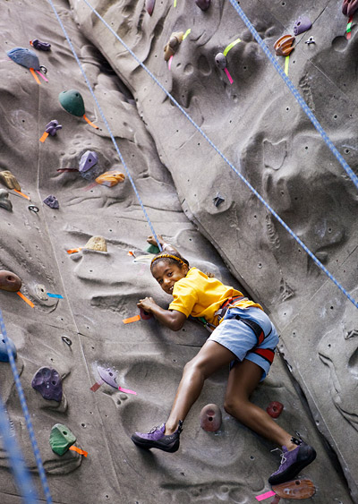 Ten-year-old Zoe Crute scales the Outdoor Action indoor rock climbing wall. It was one of many activities for children attending Reunions with their parents.