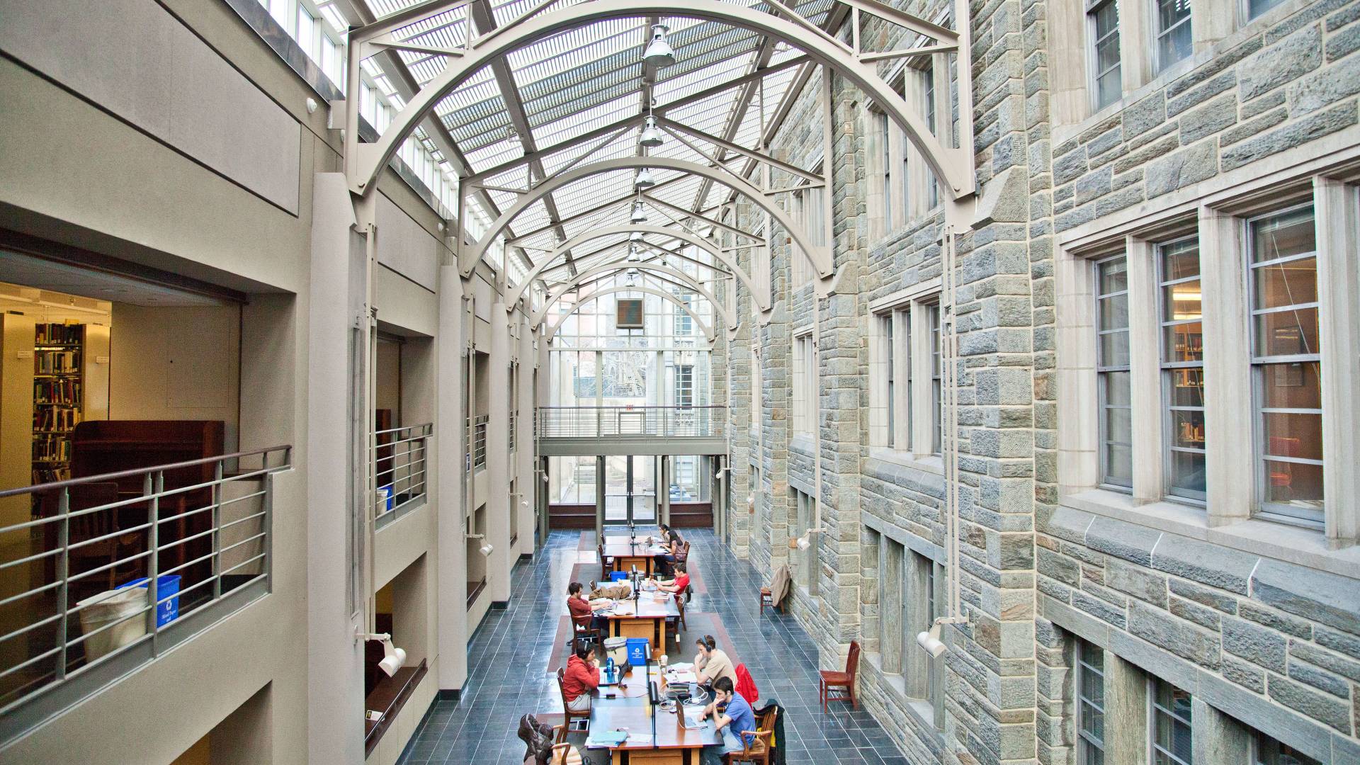 Students study in Firestone Library under skylight