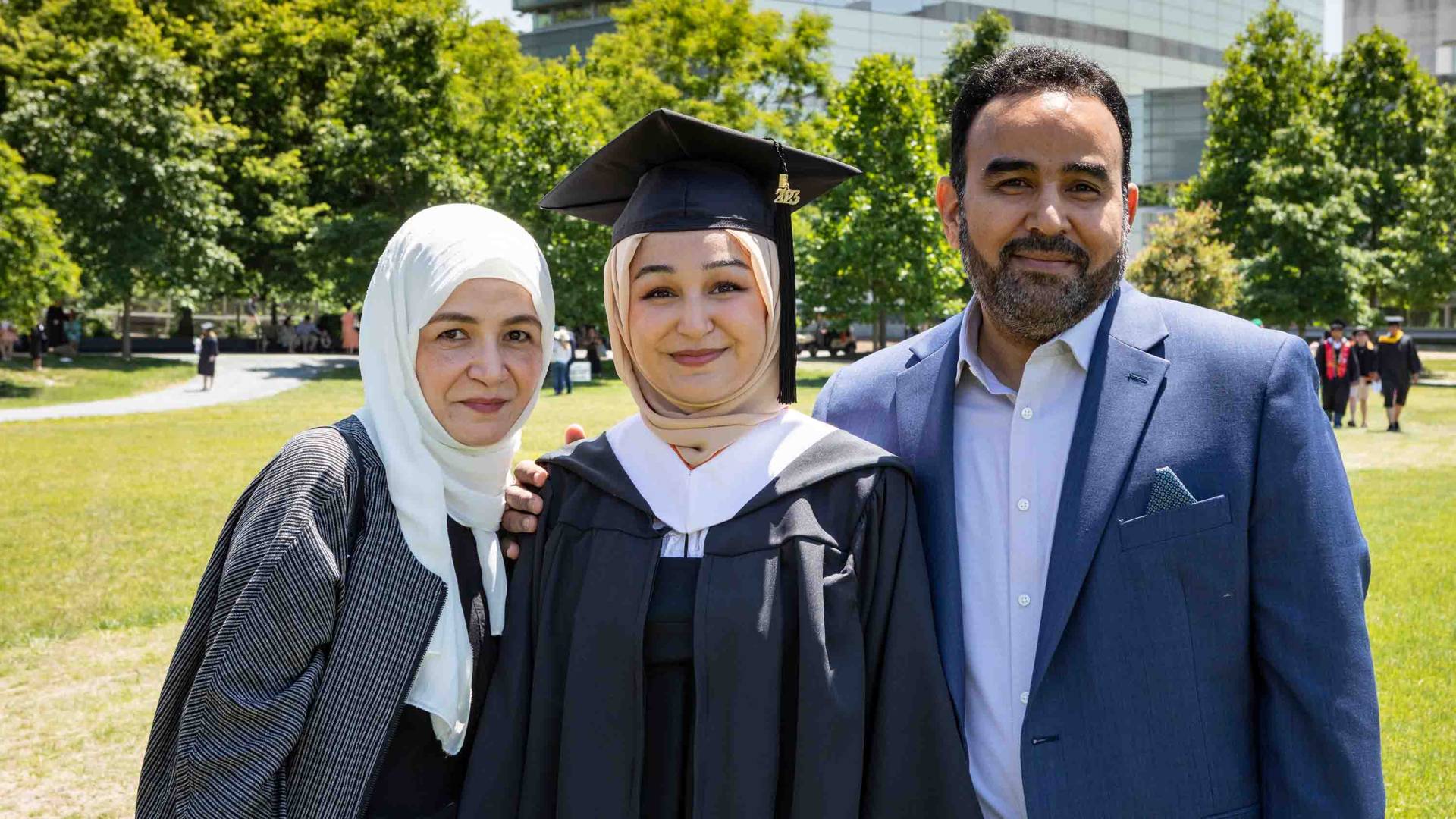 Graduate students smiling with her family