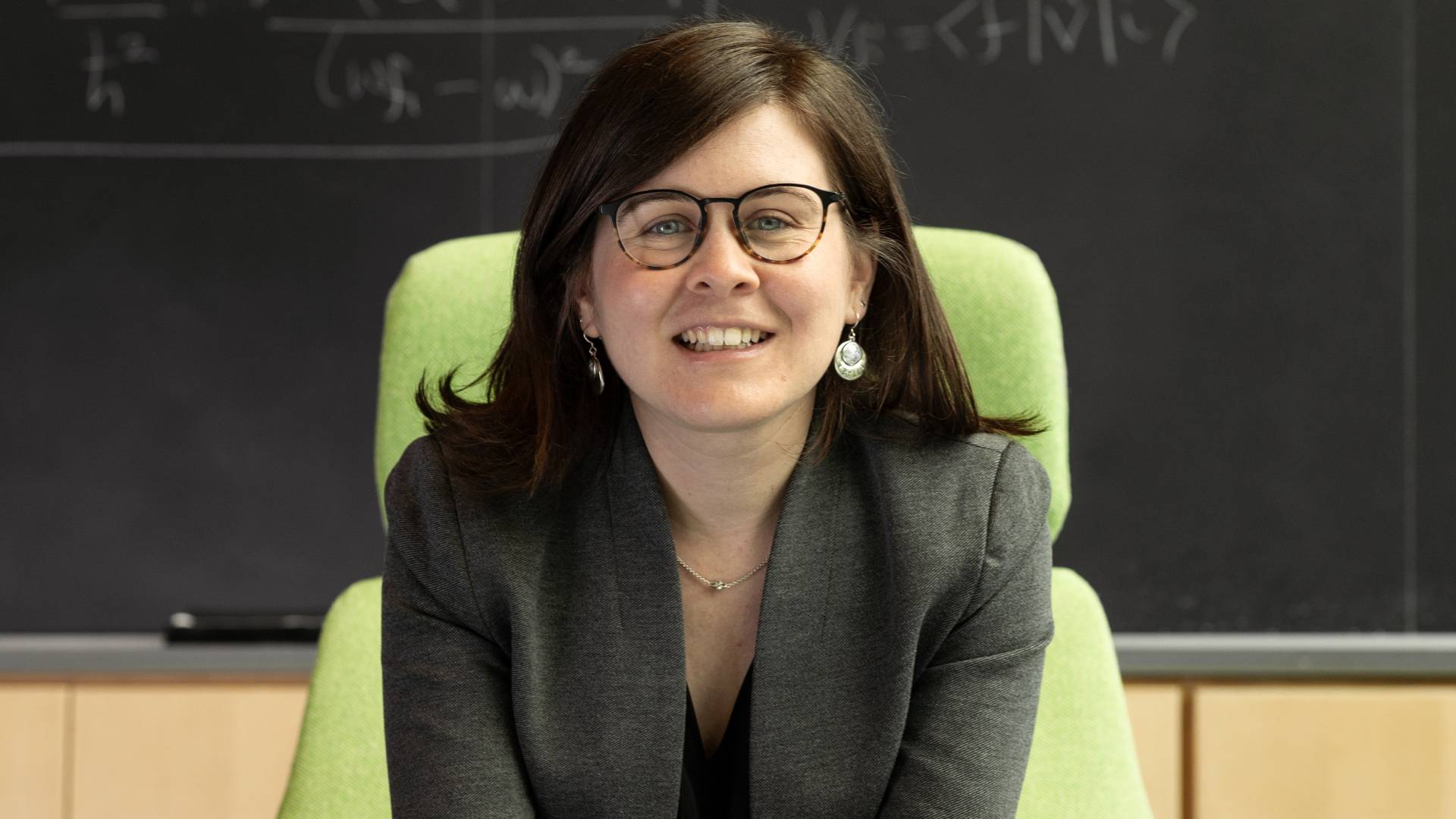 Marissa Weichman smiling in front of a chalkboard