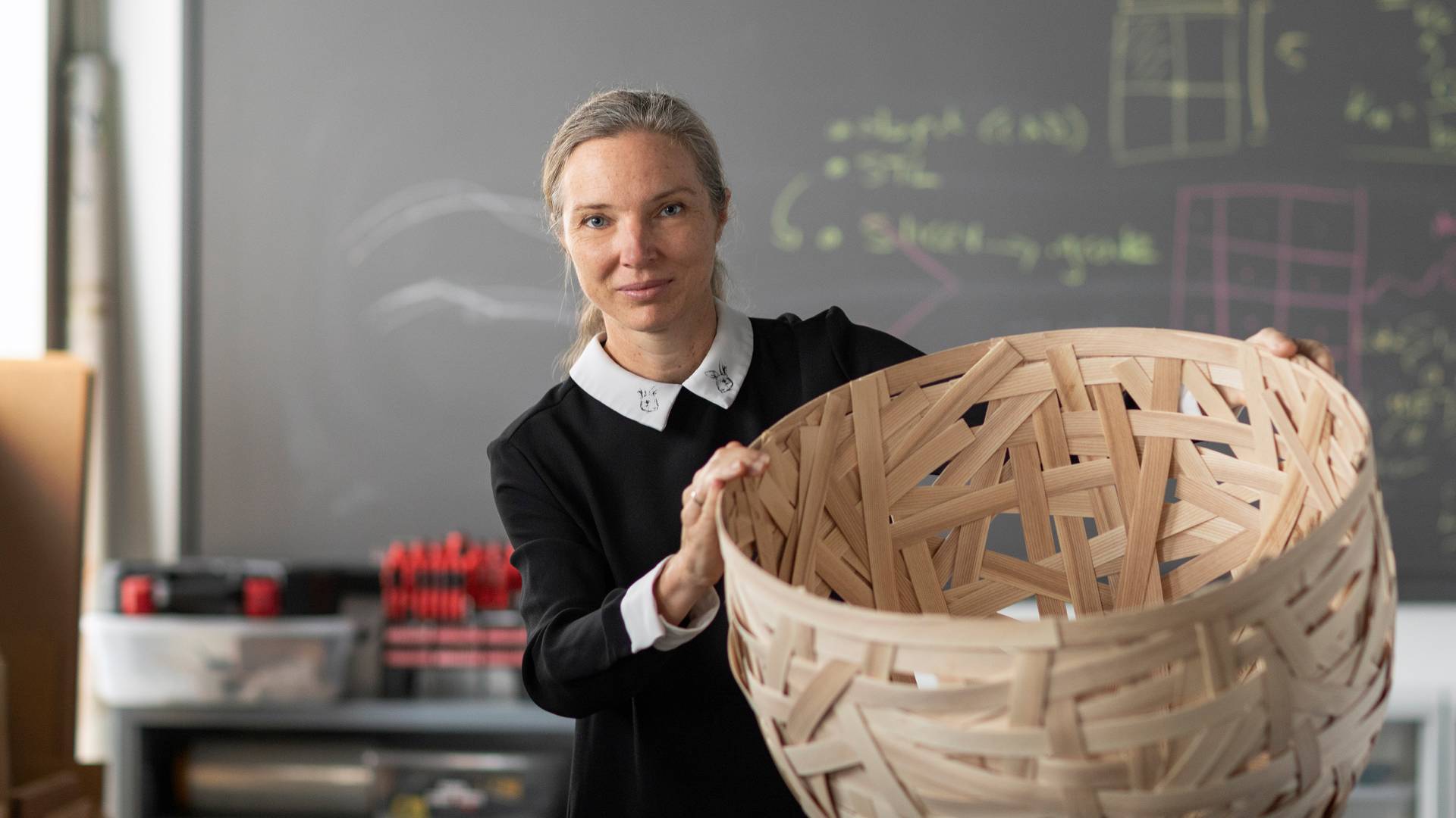Sigrid Adriaenssens holding a woven basket.