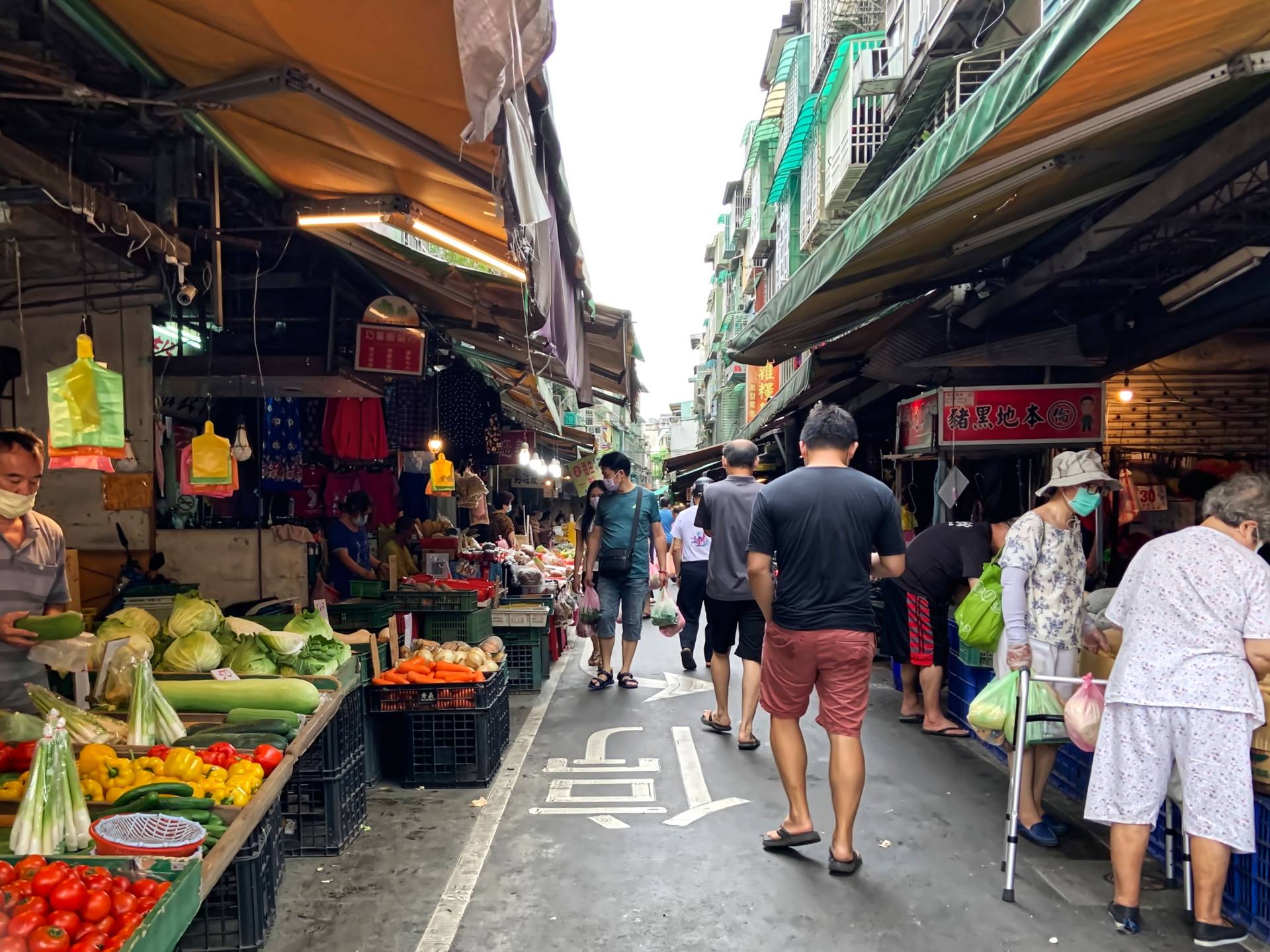 People walk through a wet market in Taiwan