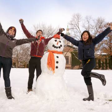 Students with snowman in winter