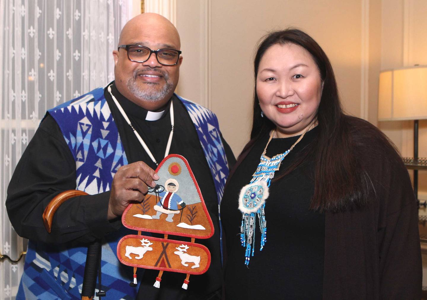 Pastor John Norwood shows his gift, geometric textile art depticting a native Arctic hunter and their catch from Olga Ulturgasheva