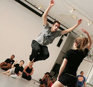 Senior Kit Tollerson takes to the air while performing a routine with sophomore Bridget Bartlett.