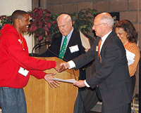 Princeton Prize founder Henry Von Kohorn (front right) presents Princeton Prize winner Sidney Johnson of Memphis with a certificate of participation