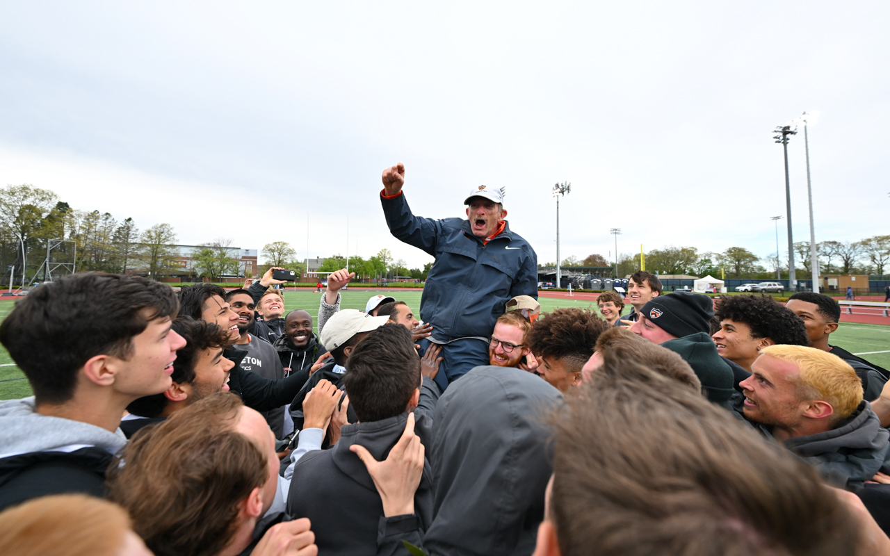 Fred Samara being carried by student athletes