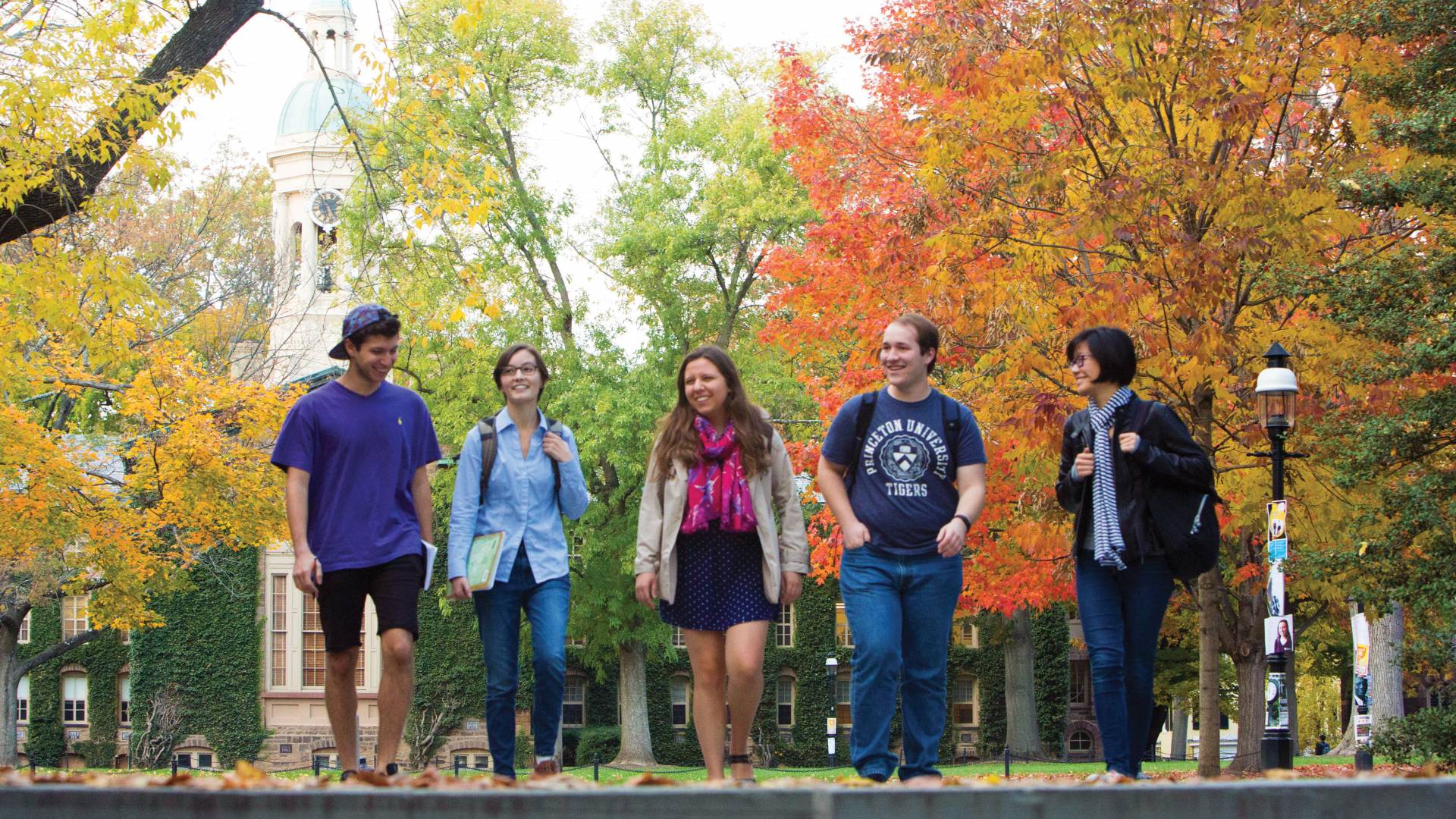 Students walking in a line away from Nassau Hall during Fall
