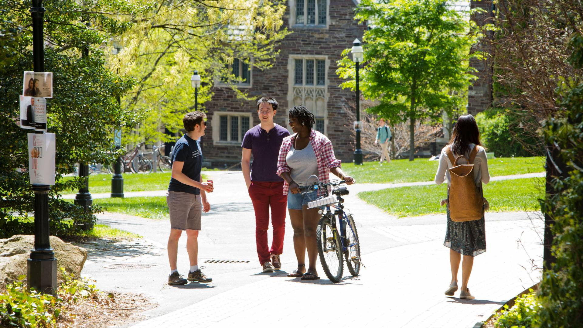 students walking along path through campus