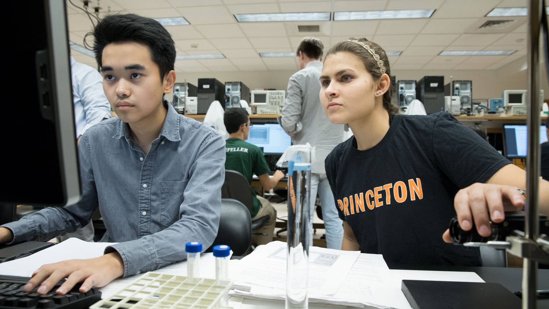 Students looking at computer in lab