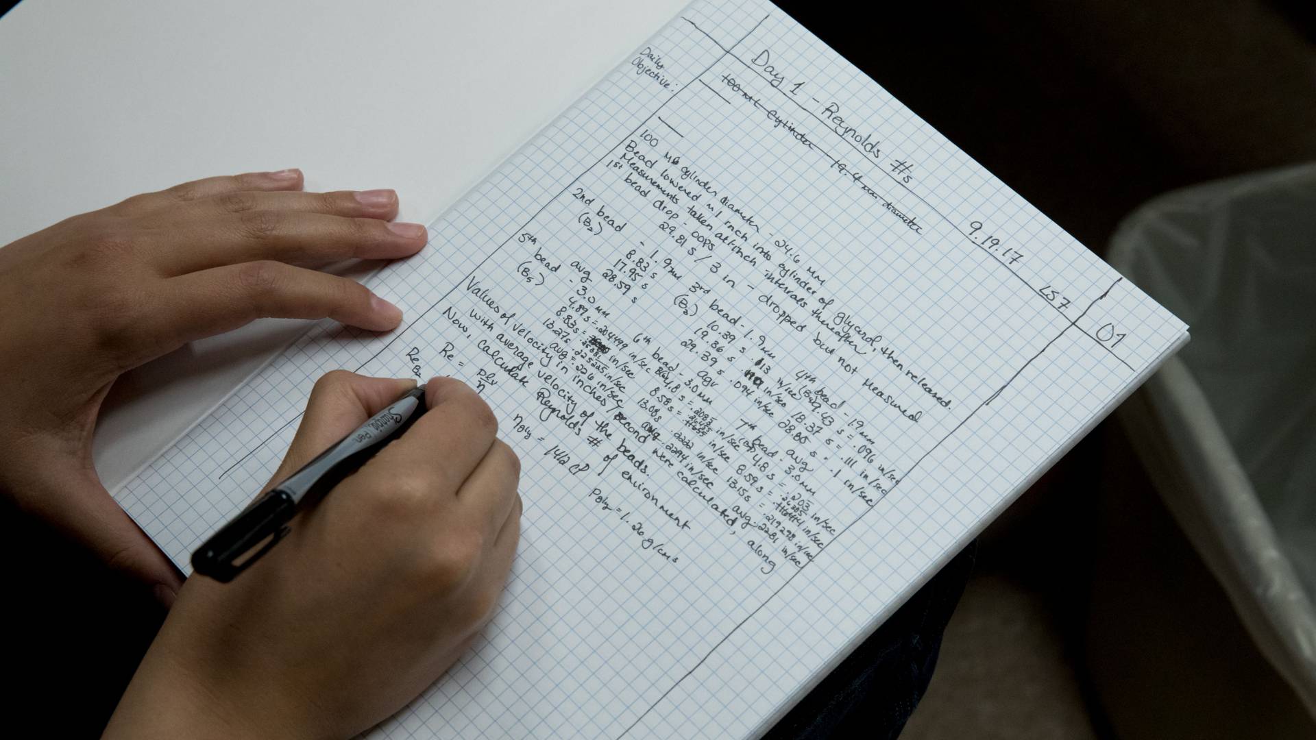 Student writing in notebook
