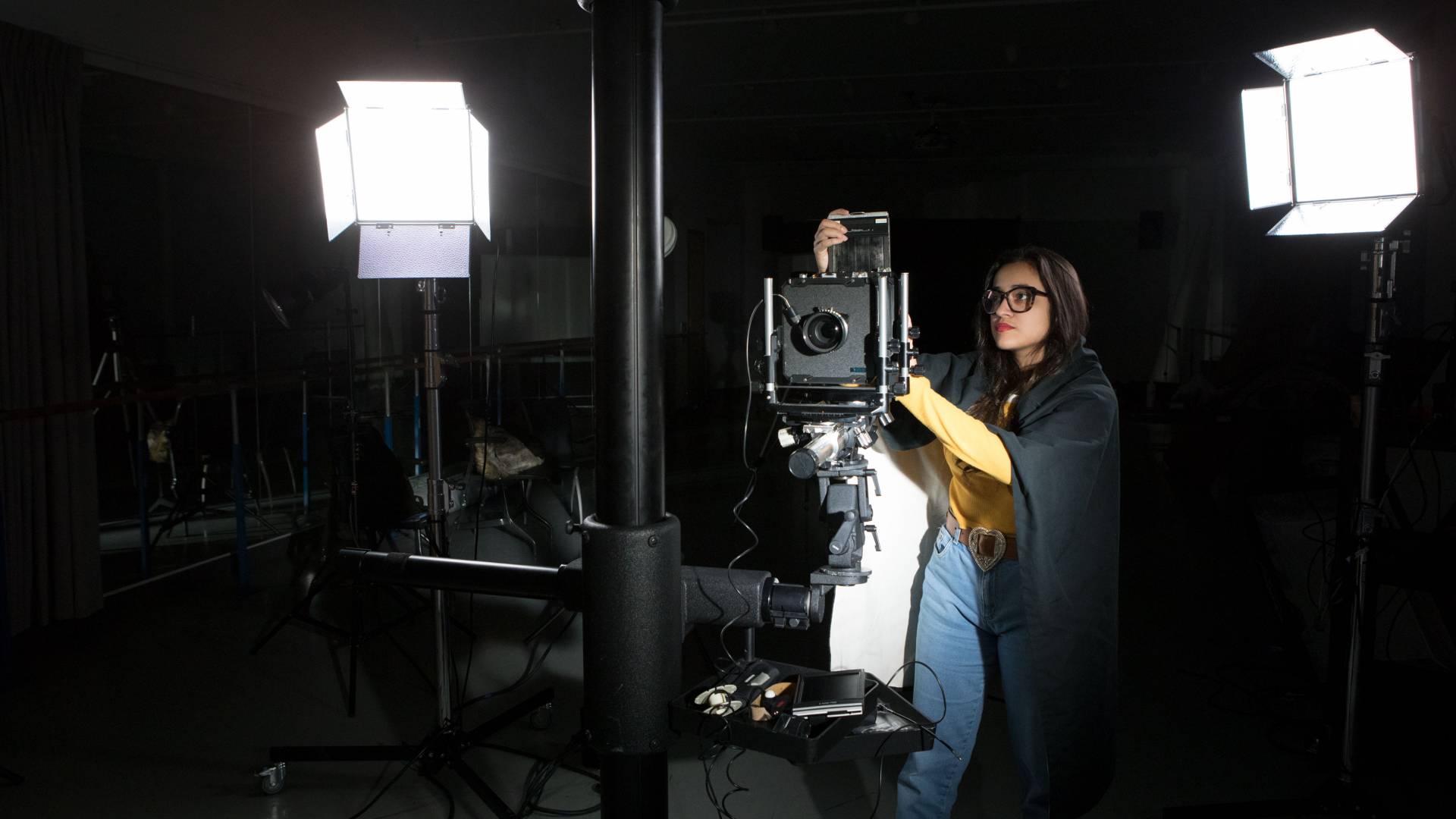 Angelica prepares large format camera in studio