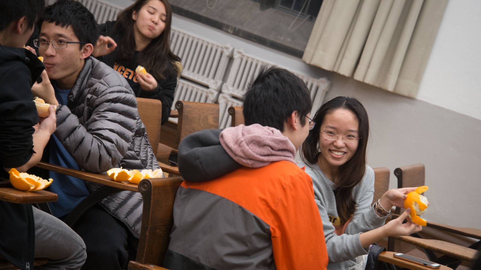 Students eating and peeling oranges