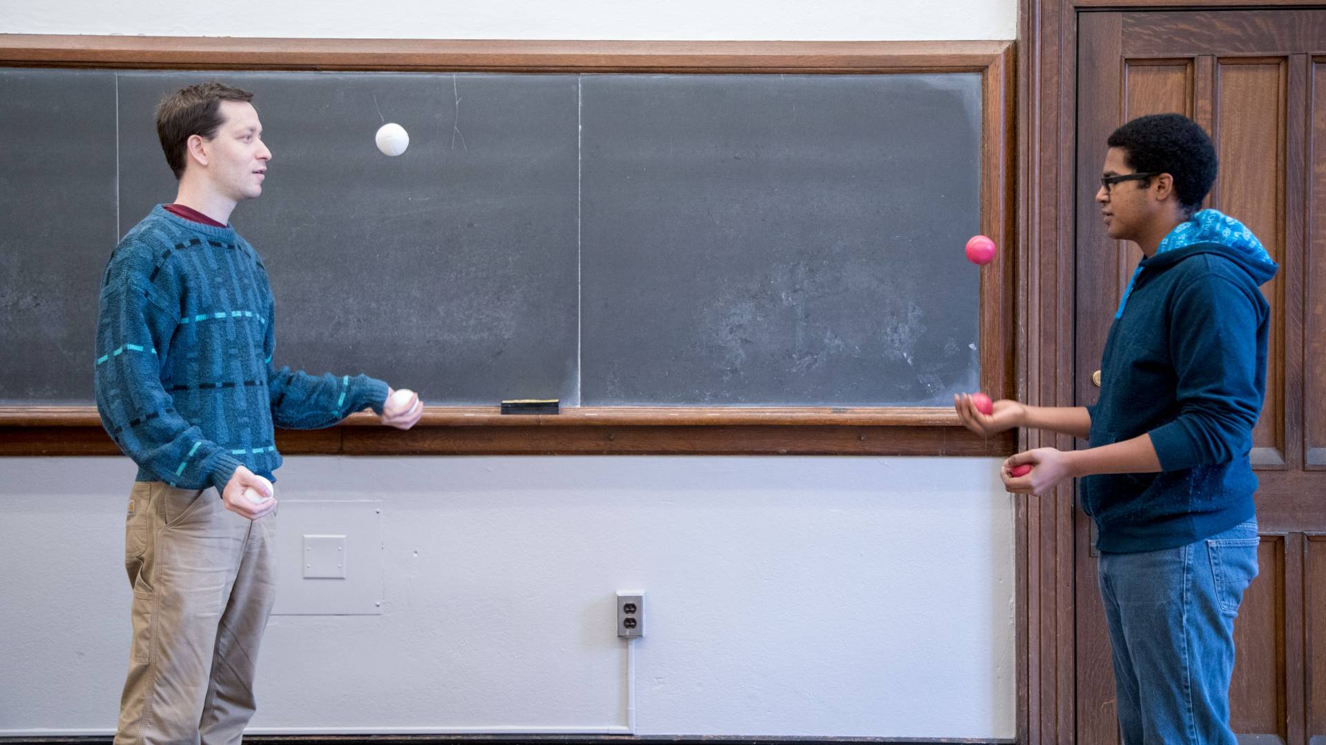 Students juggling in classroom