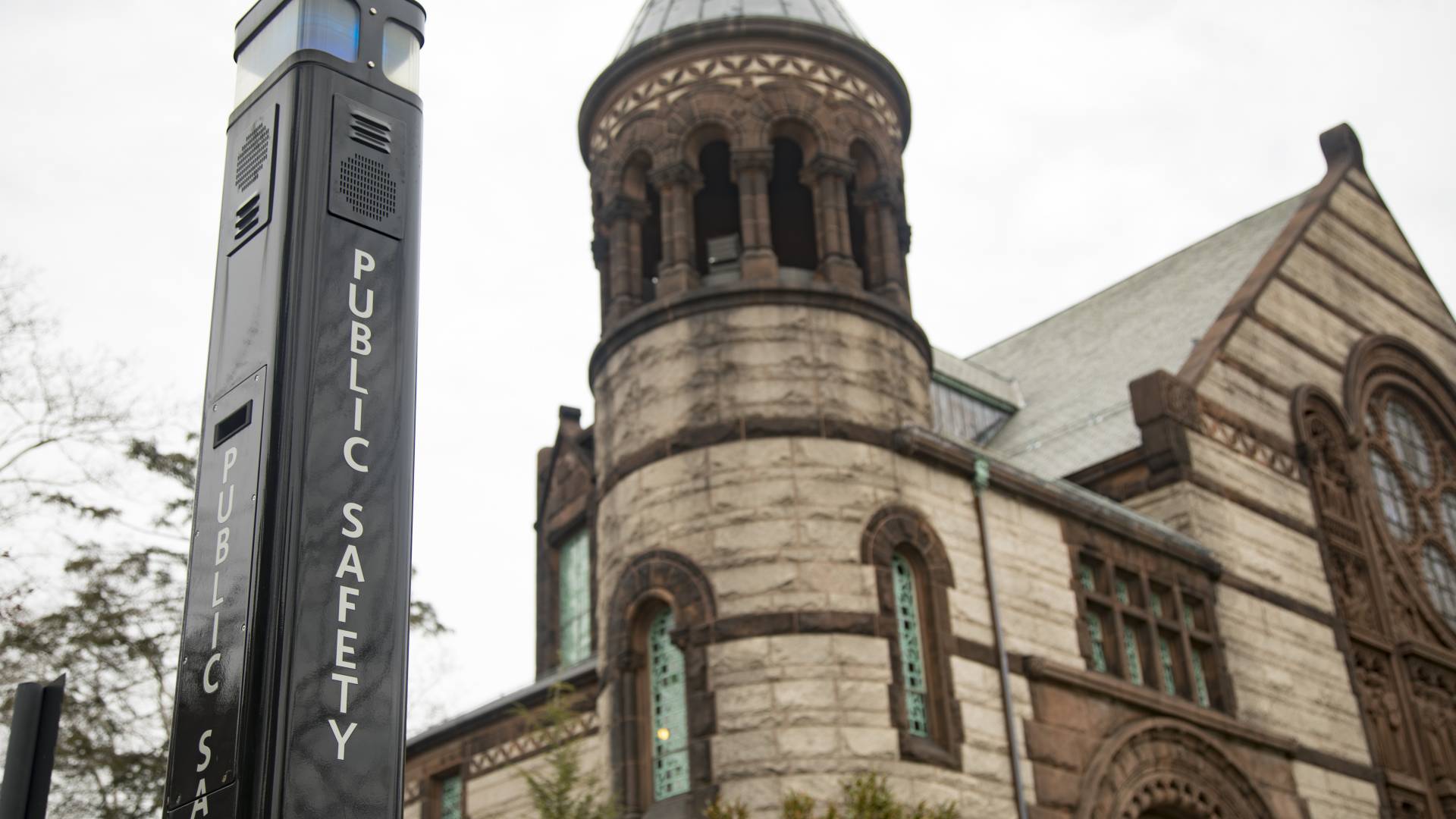 A photo of a blue light communication tower in front of Alexander Hall