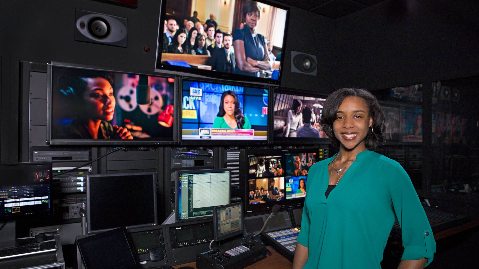 Taylor Griffith standing in front of TV screens