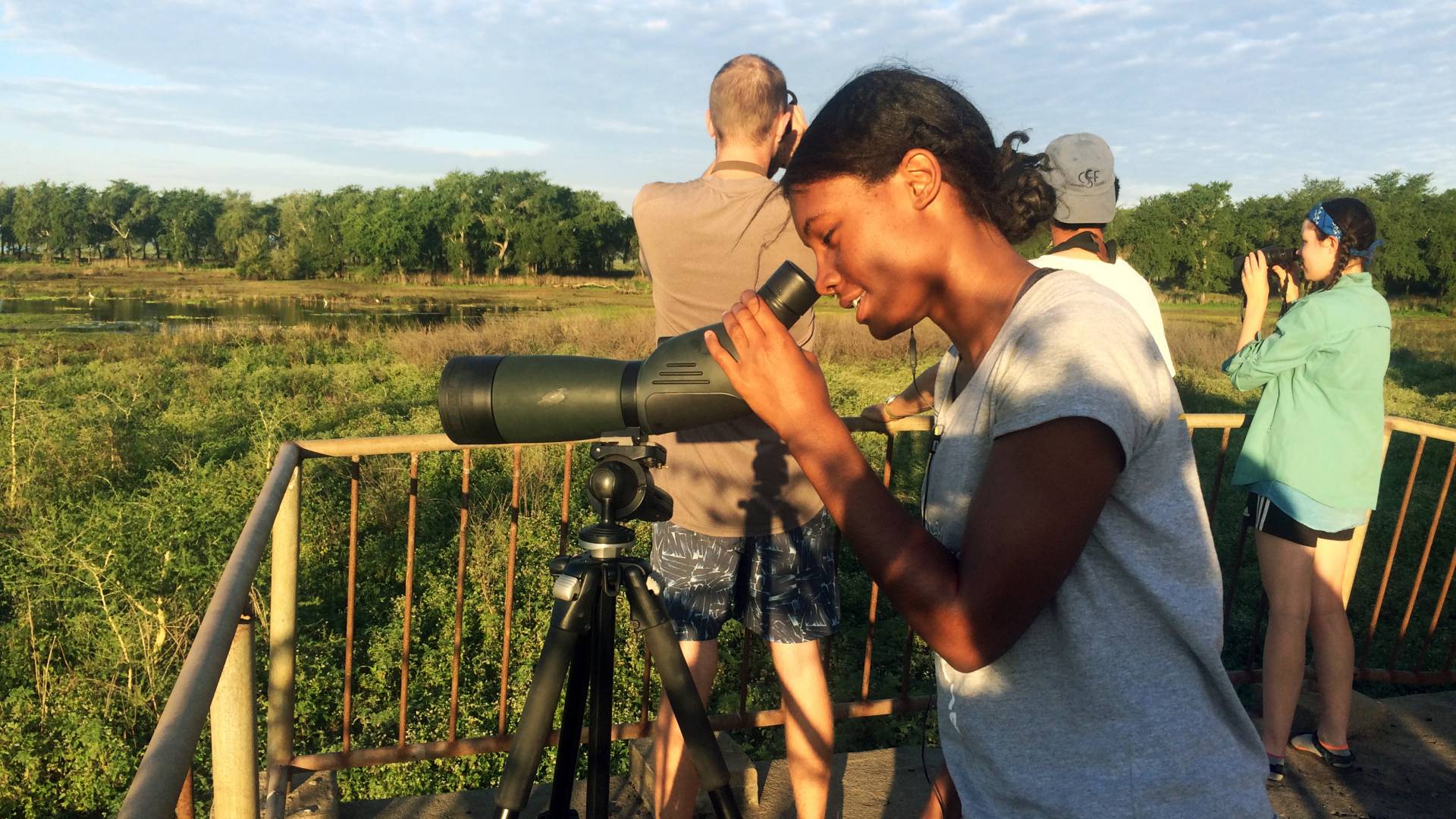 Alana Reynolds looks through binoculars