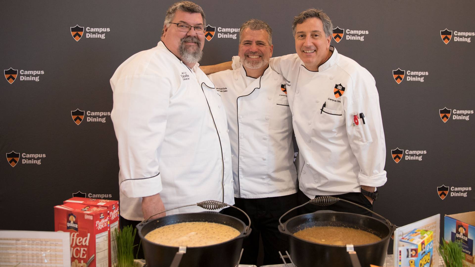 3 chefs standing in front of cooked grains