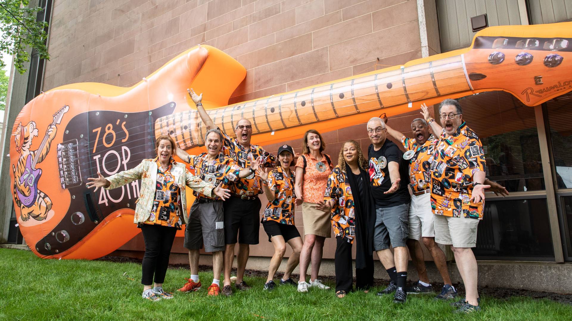 Members of Class of 1978 posing in front of giant balloon guitar