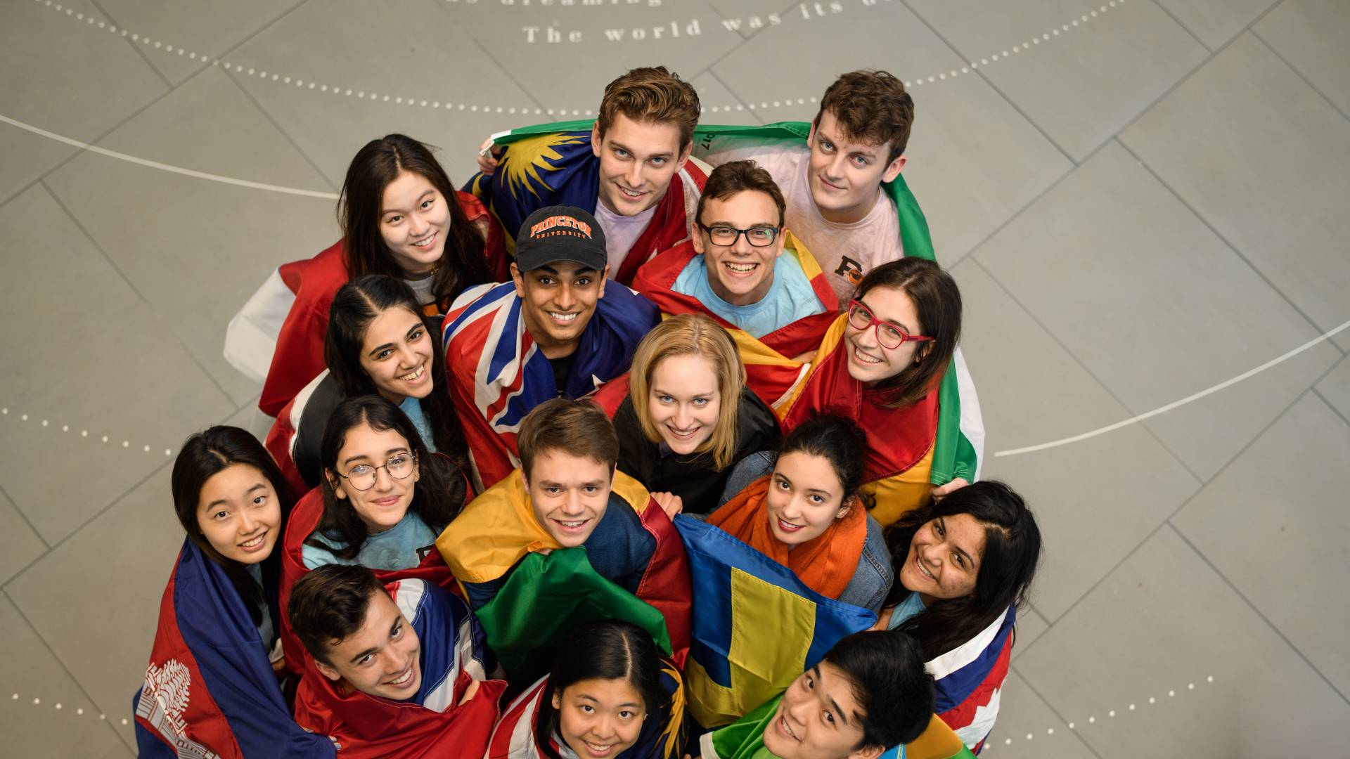 Overhead view of students wrapped in flags