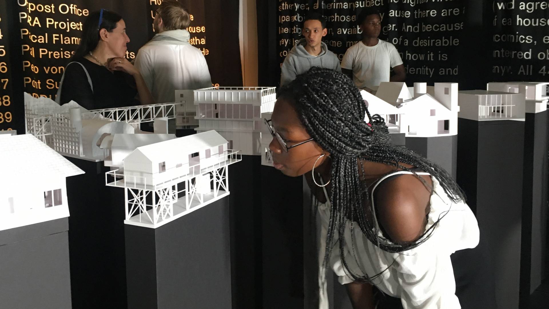 Students look around the Architecture exhibit with Dean Mónica Ponce de León