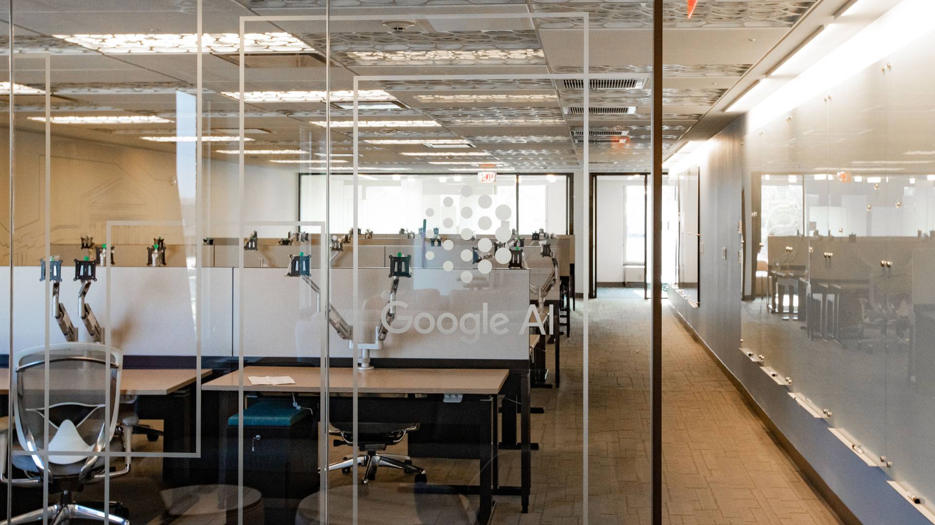 Office space with "Google AI" etched on glass door
