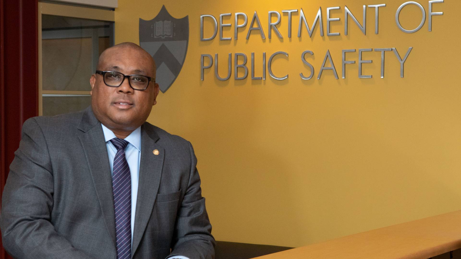 Kenneth Strother Jr standing by Department of Public Safety sign