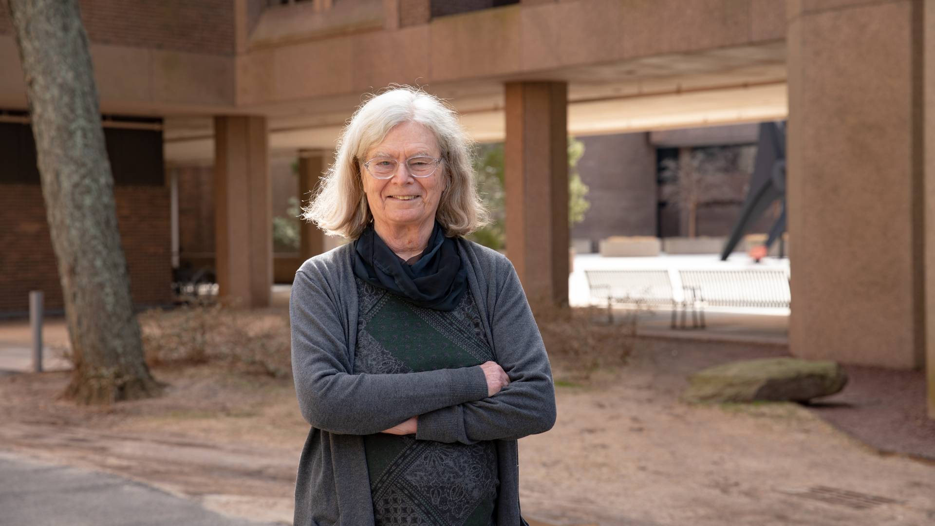 Karen Uhlenbeck poses in front of the math building