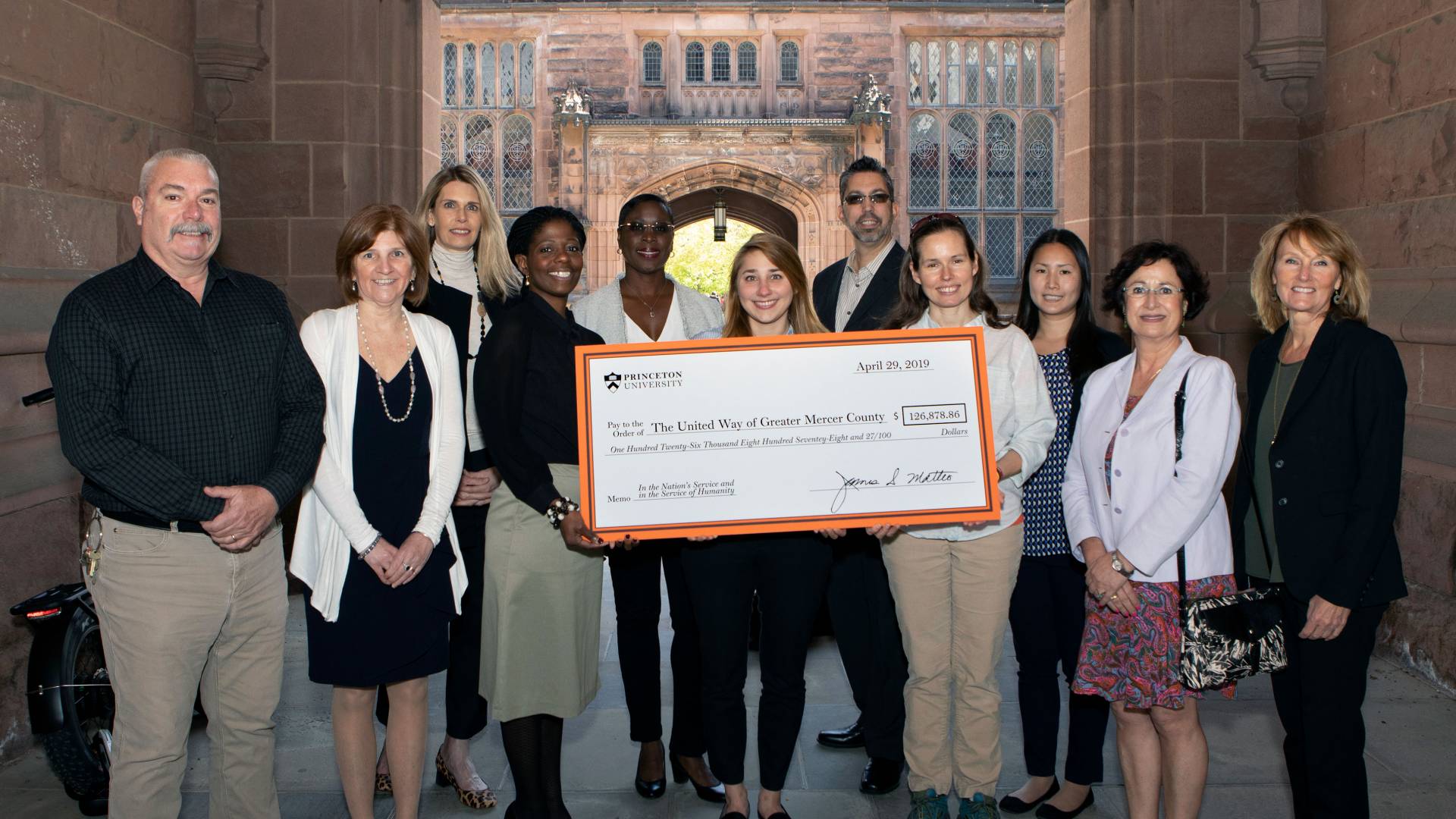 Staff members pose with a giant check from Princeton to the United Way