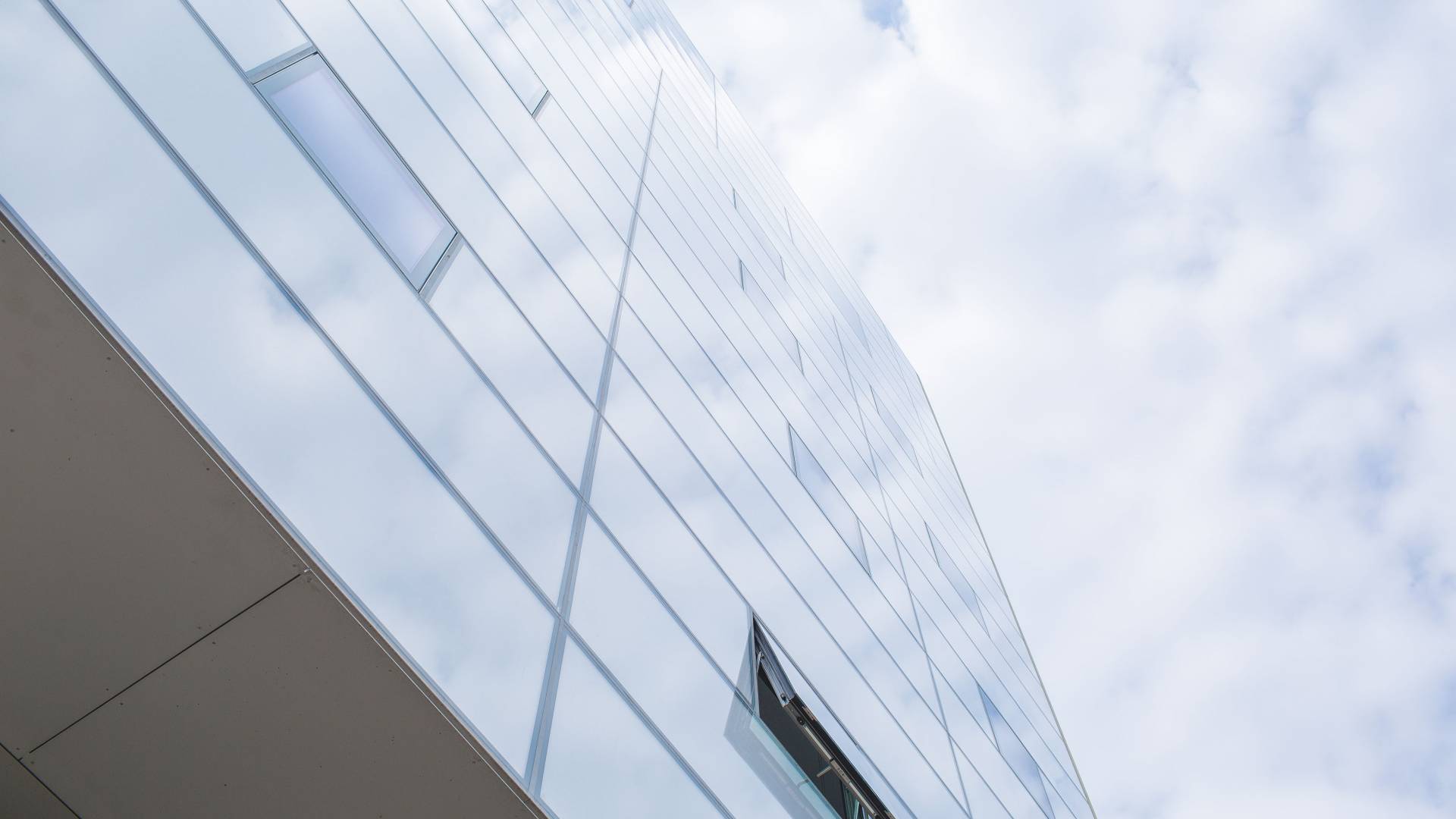 Building reflecting a cloudy sky