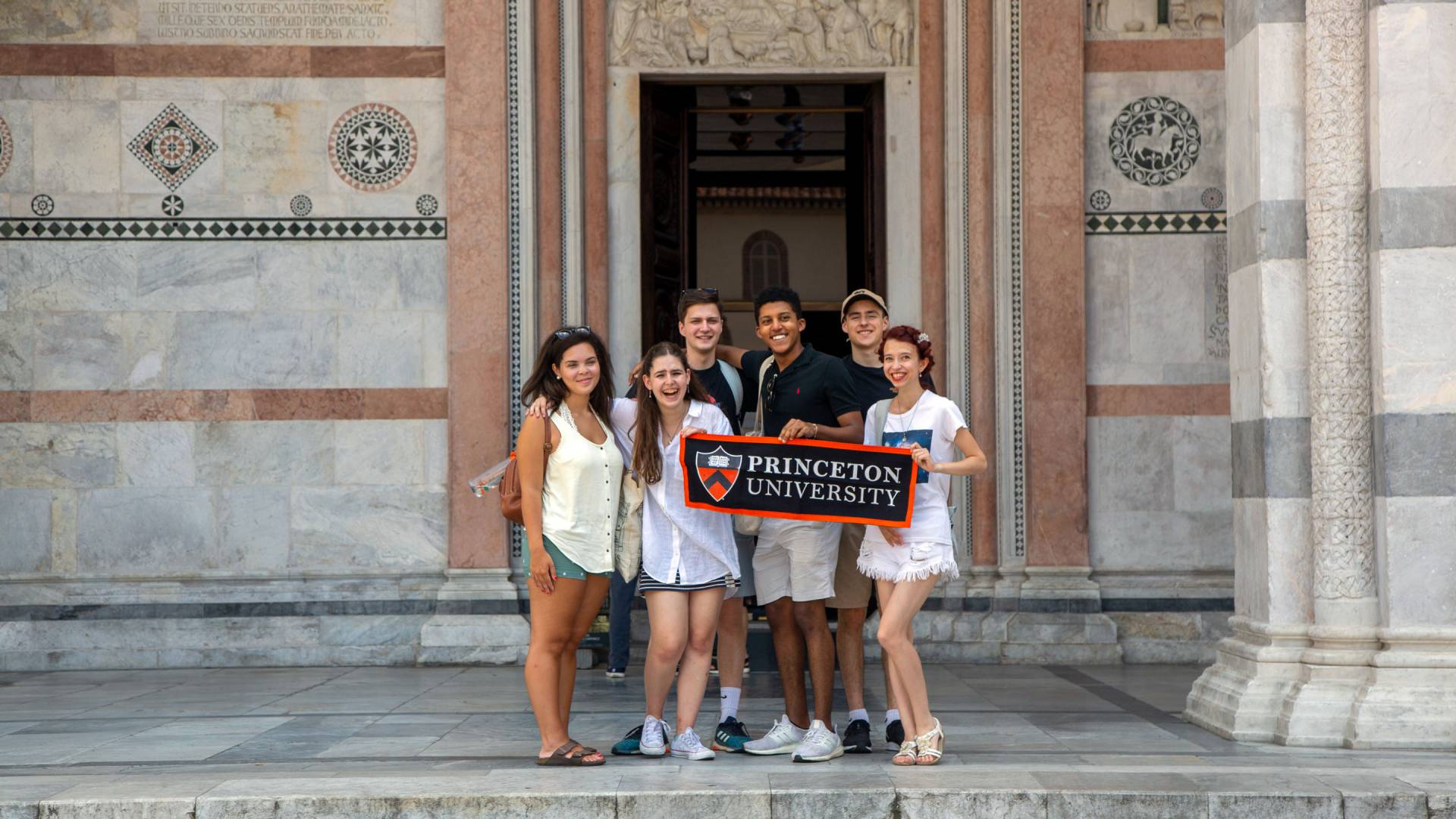 Students standing holding Princeton University banner