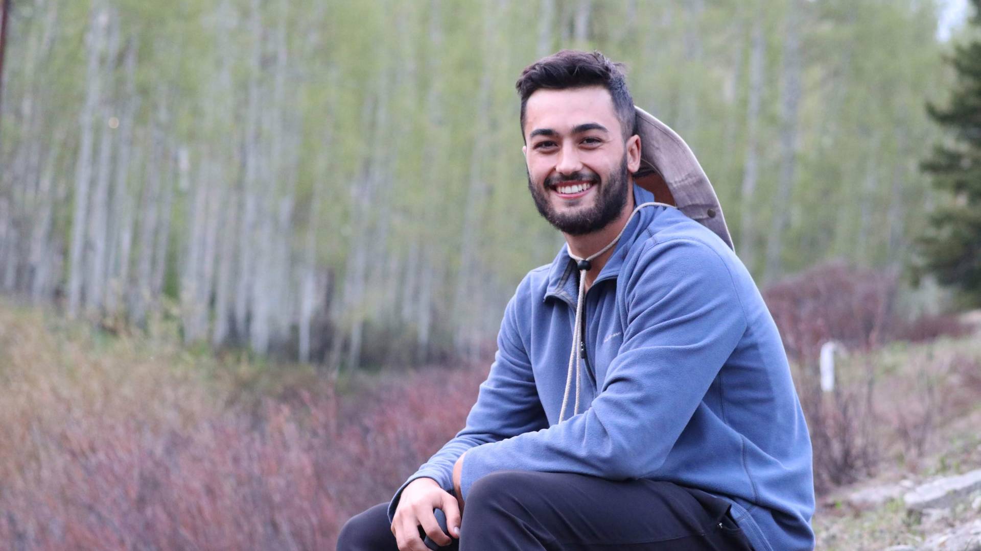 Cole Morokhovich sits in a field